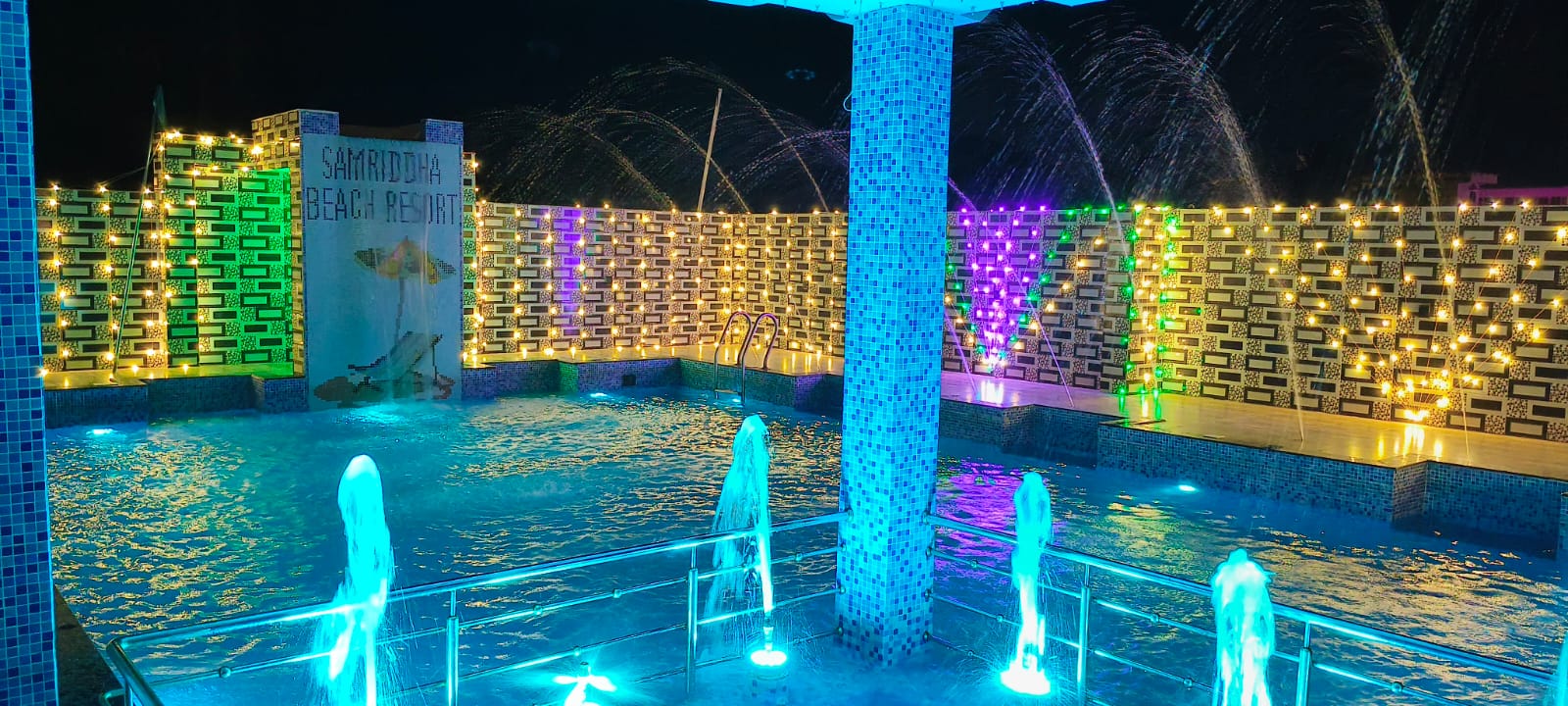 Night Swimming Pool with Waterfall Fountains